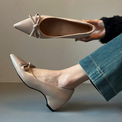 Zapatos de charol con elevación interna que estilizan la figura